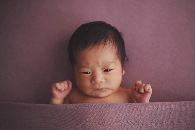cute frowning newborn baby girl
