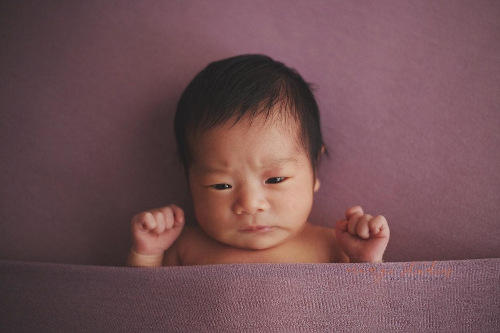 cute frowning newborn baby girl