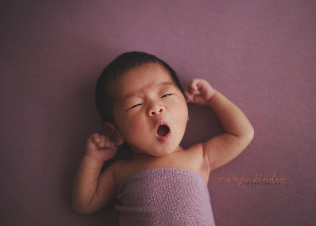 yawning 11 days old newborn baby girl