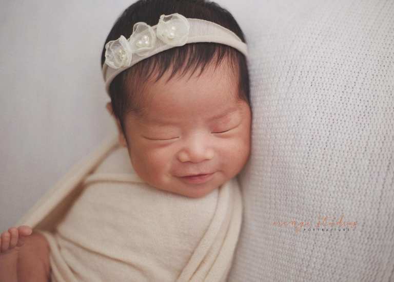 smiling newborn baby girl
