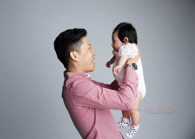dad and cute baby girl family portraits in singapore studio