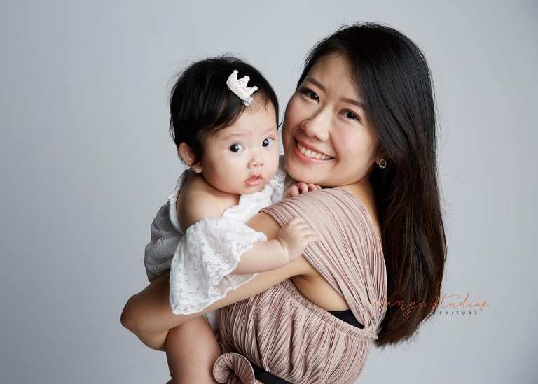 mum and cute baby girl family portraits in singapore studio