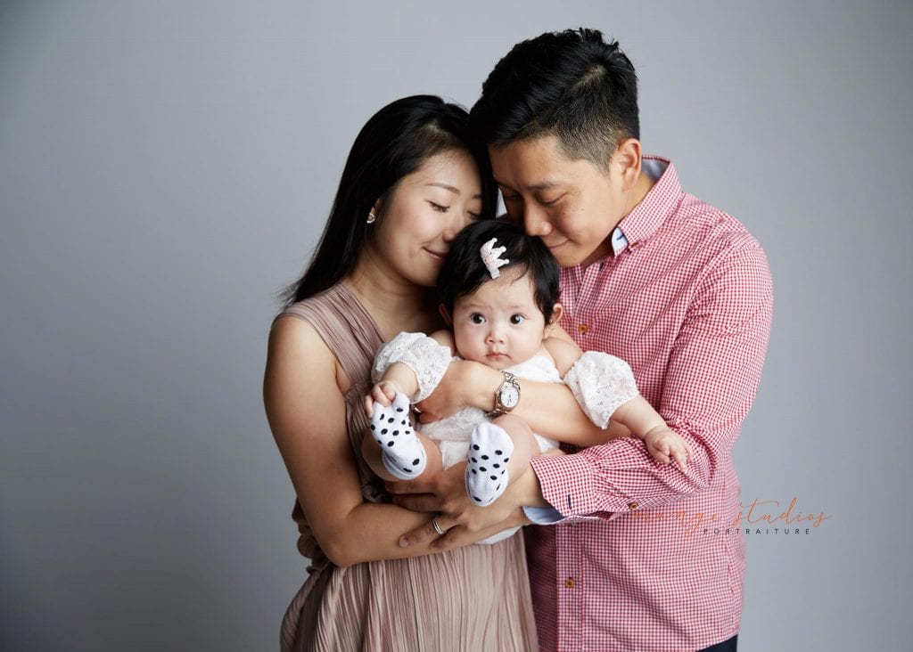 adorable baby girl and parents family portraits in singapore studio