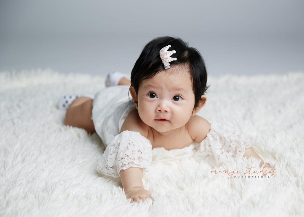 cute baby girl tummy down portraits in singapore studio