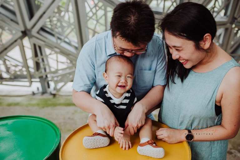 1 year old baby boy with parents in outdoor family portraits