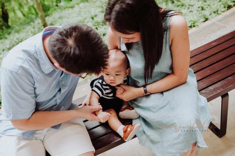 1 year old baby boy with parents in outdoor family portraits