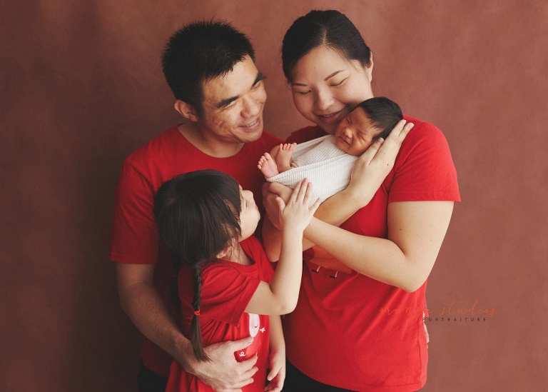 8 days old baby boy with family newborn portraits in singapore studio