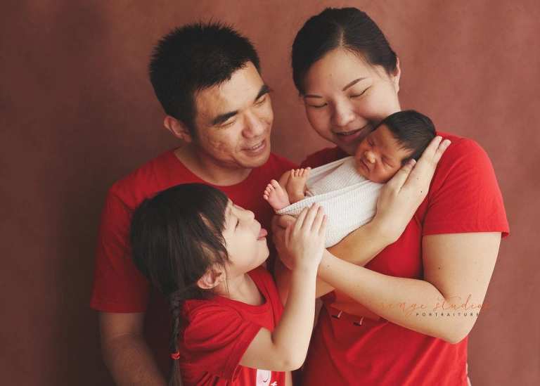 8 days old baby boy with family newborn portraits in singapore studio