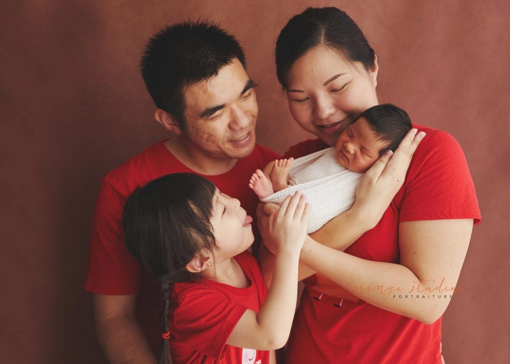 8 days old baby boy with family newborn portraits in singapore studio