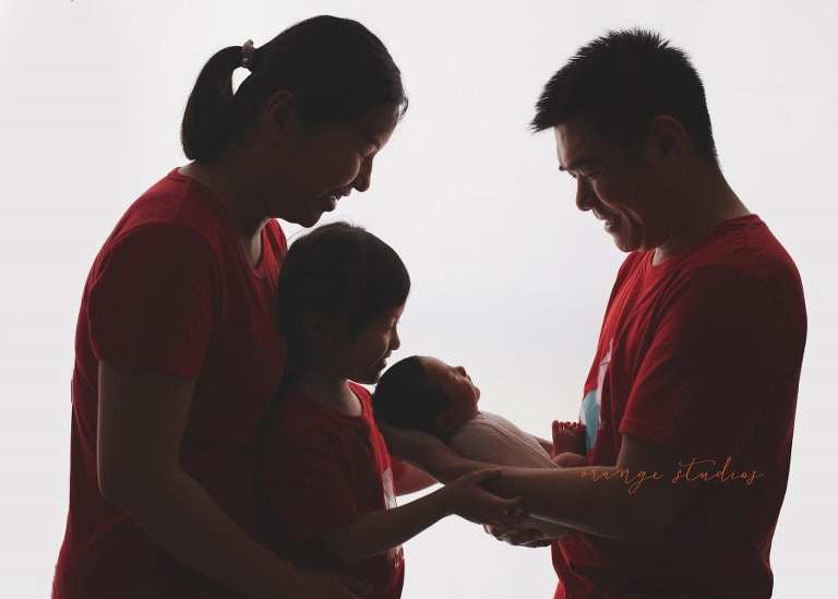 8 days old baby boy with family newborn portraits in singapore studio