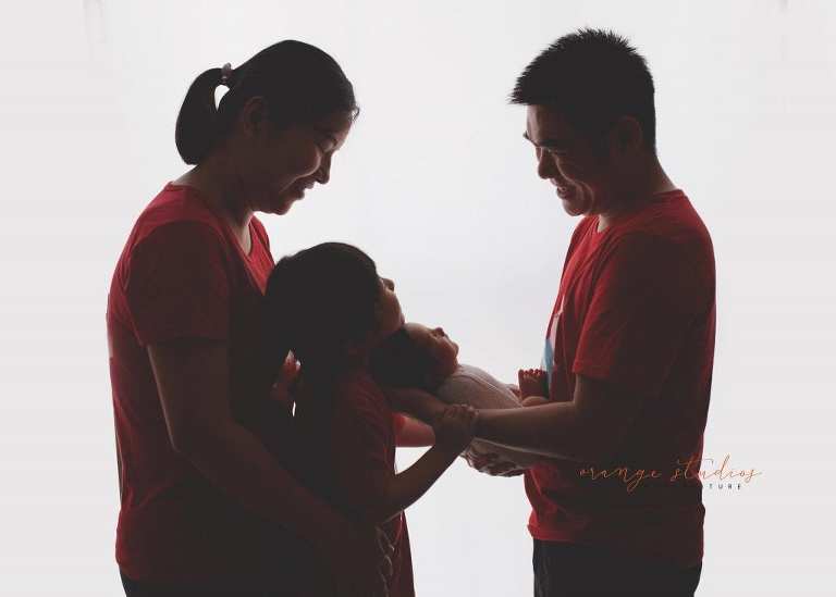 8 days old baby boy with family newborn portraits in singapore studio
