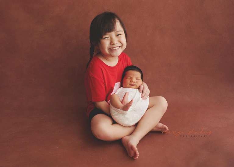 8 days old baby boy newborn portraits with elder sister in singapore studio