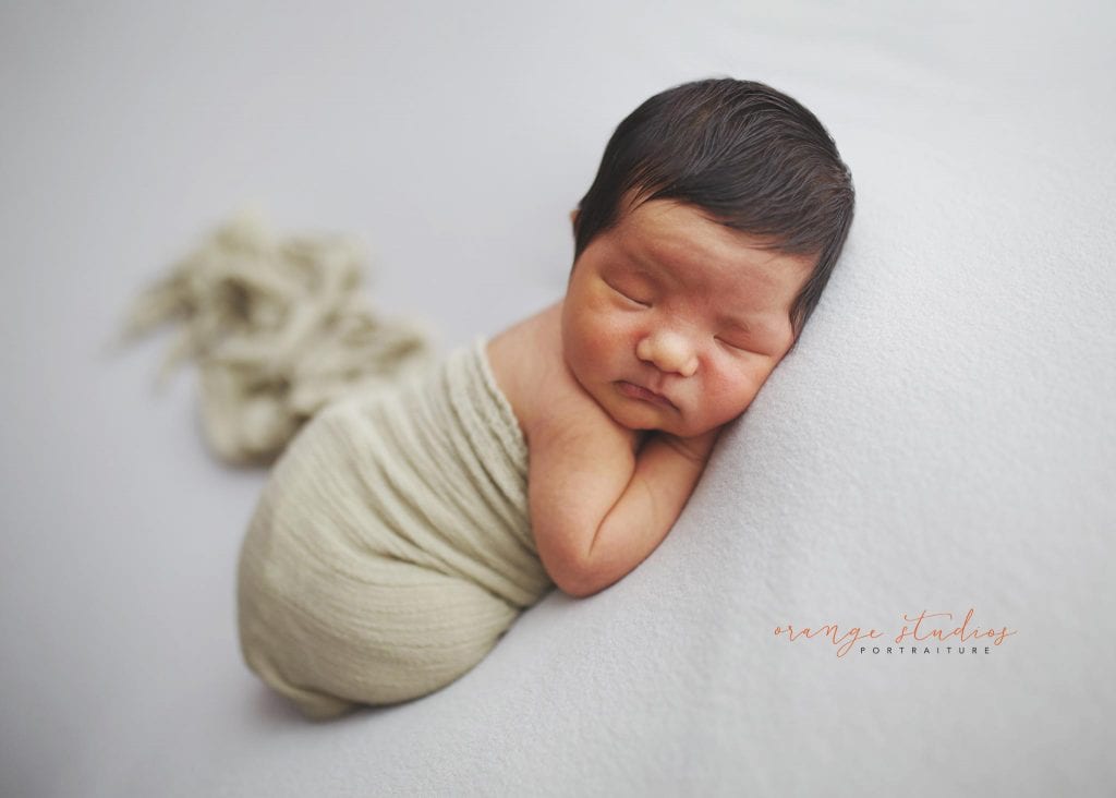 8 days old baby boy tummy down newborn portraits in singapore studio