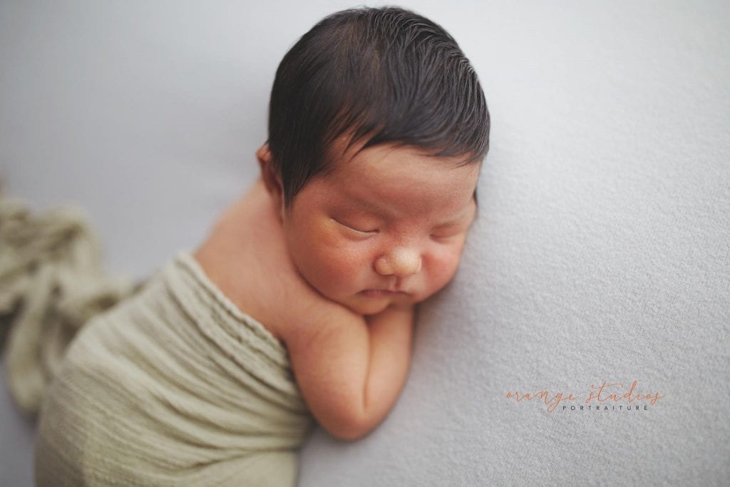 8 days old baby boy tummy down newborn portraits in singapore studio