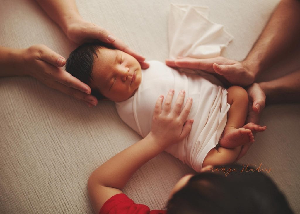 8 days old baby boy with family newborn portraits in singapore studio