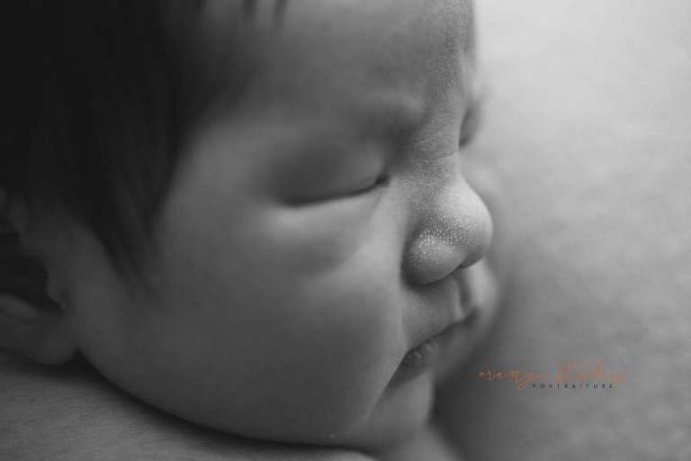 8 days old baby boy milia on nose black and white newborn portraits in singapore studio