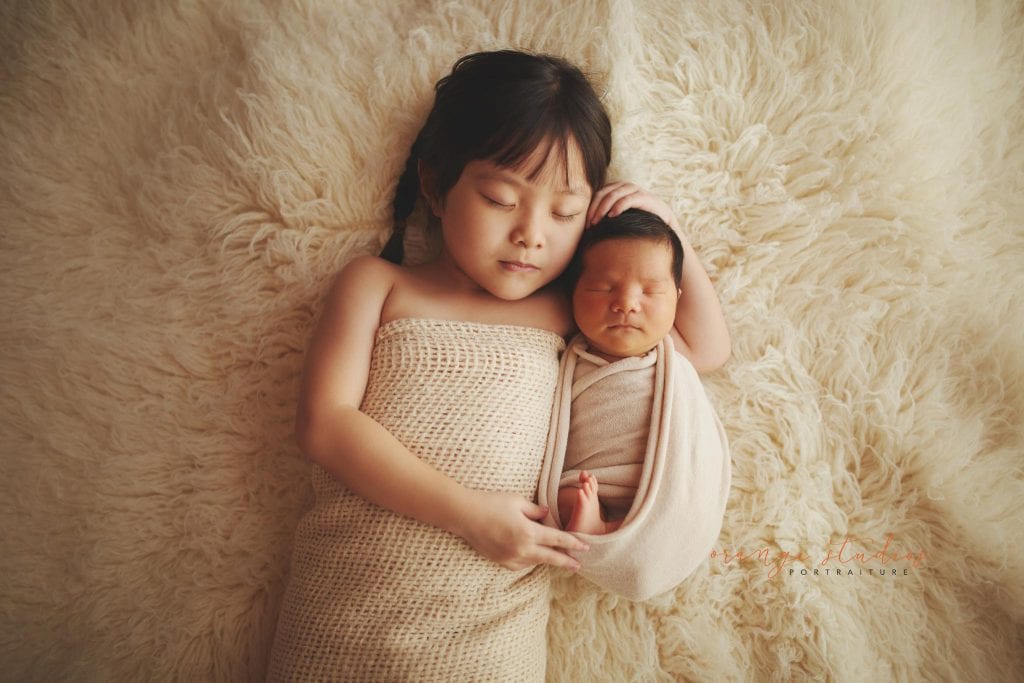8 days old baby boy newborn portraits with elder sister in singapore studio