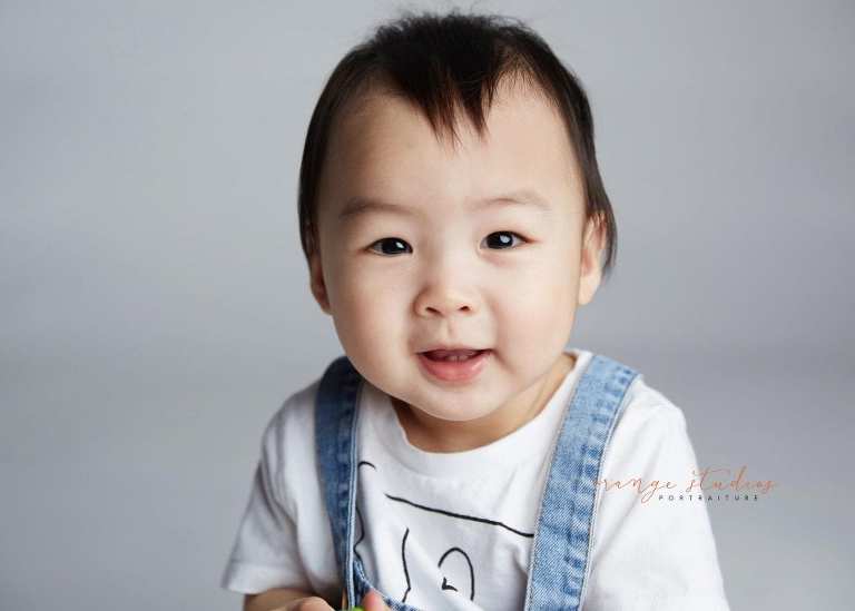 smiling 1 year old baby boy portraits in singapore studio