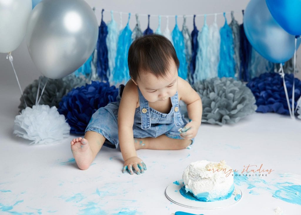 1 year old baby boy blue and grey theme cake smash portraits in singapore studio