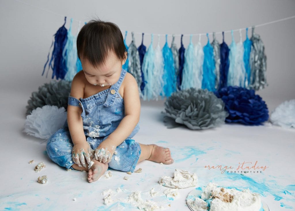 1 year old baby boy blue and grey theme cake smash portraits in singapore studio