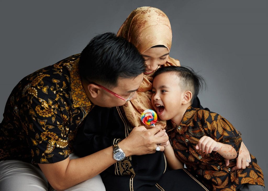 maternity portraits with family having fun in singapore studio