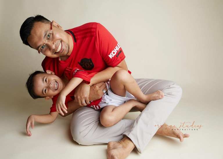 family portrait of dad and son playing in singapore studio