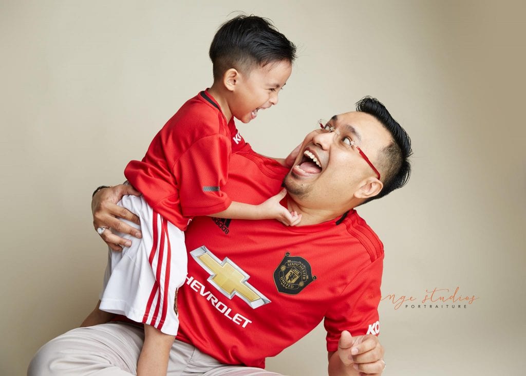 family portrait of dad and son having fun in singapore studio