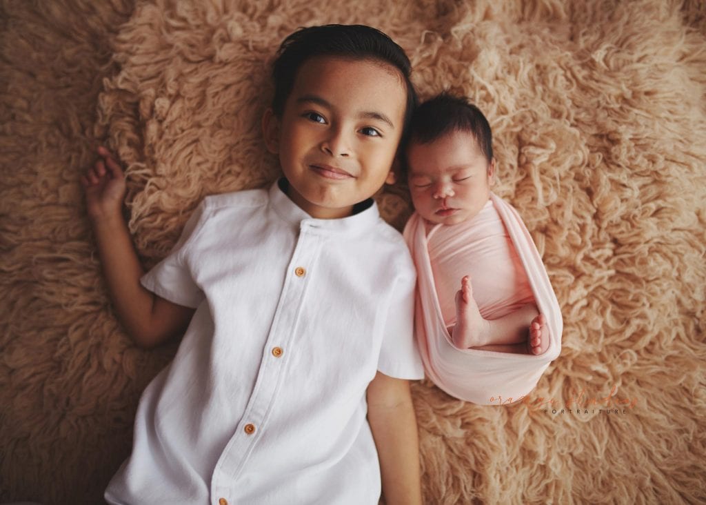 7 days old baby girl newborn portraits with elder brother in singapore studio