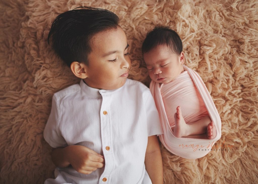 7 days old baby girl newborn portraits with elder brother in singapore studio