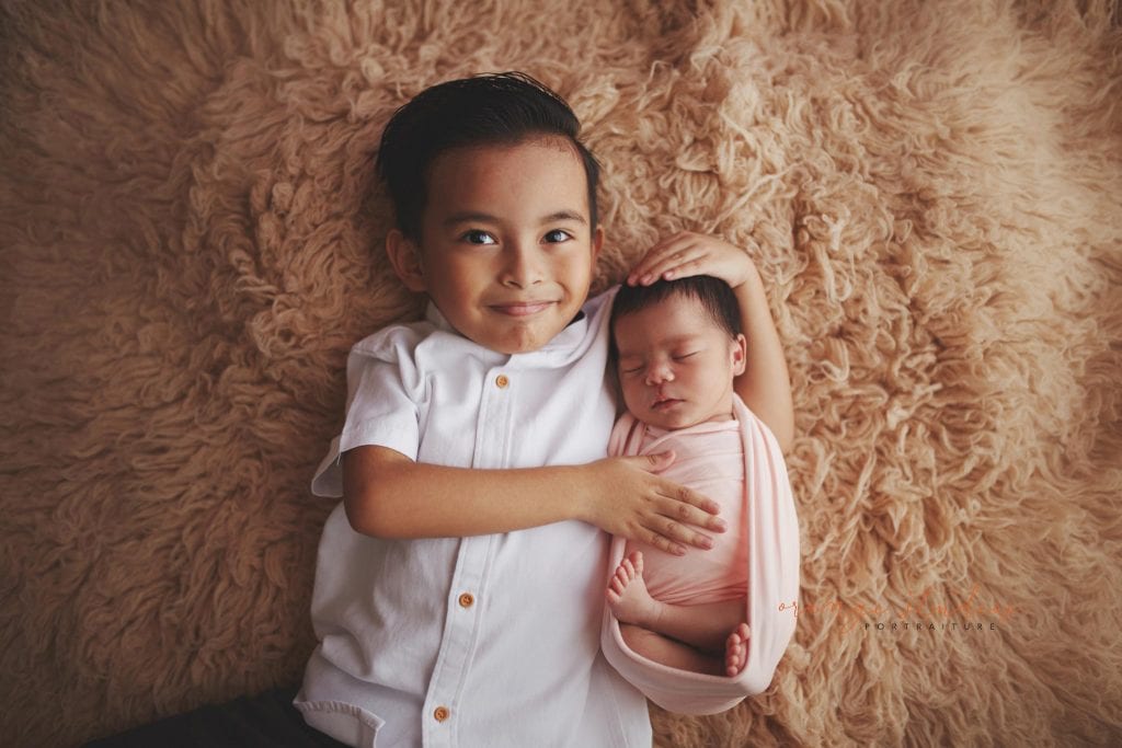 7 days old baby girl newborn portraits with elder brother in singapore studio