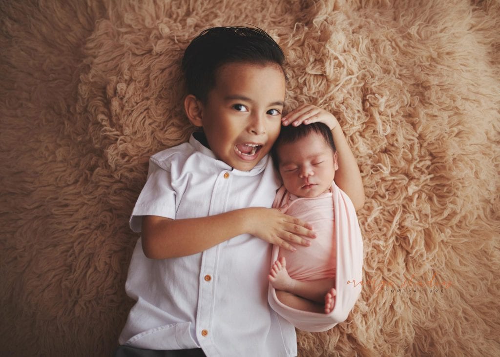 7 days old baby girl newborn portraits with elder brother in singapore studio