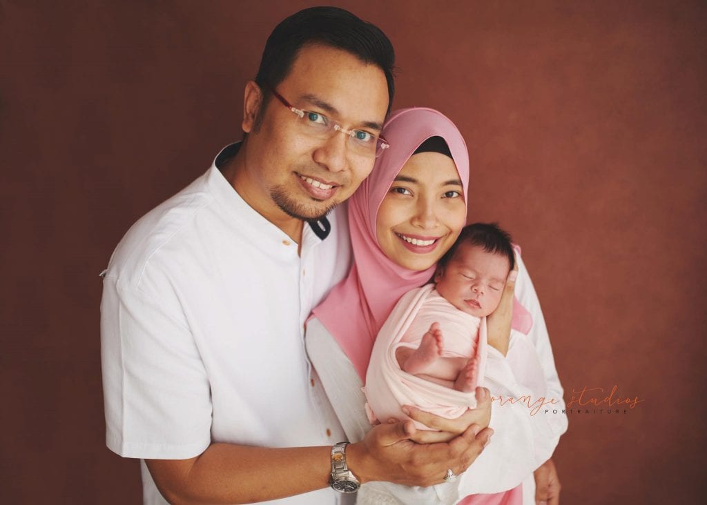7 days old baby girl newborn portraits with parents in singapore studio