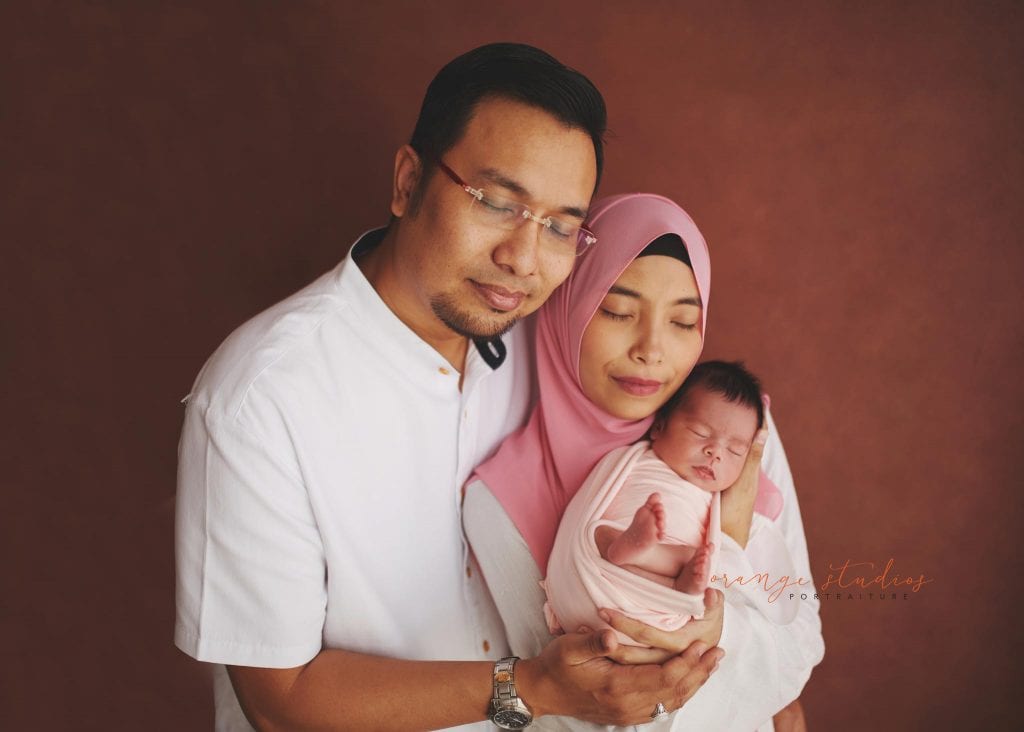 7 days old baby girl newborn portraits with parents in singapore studio