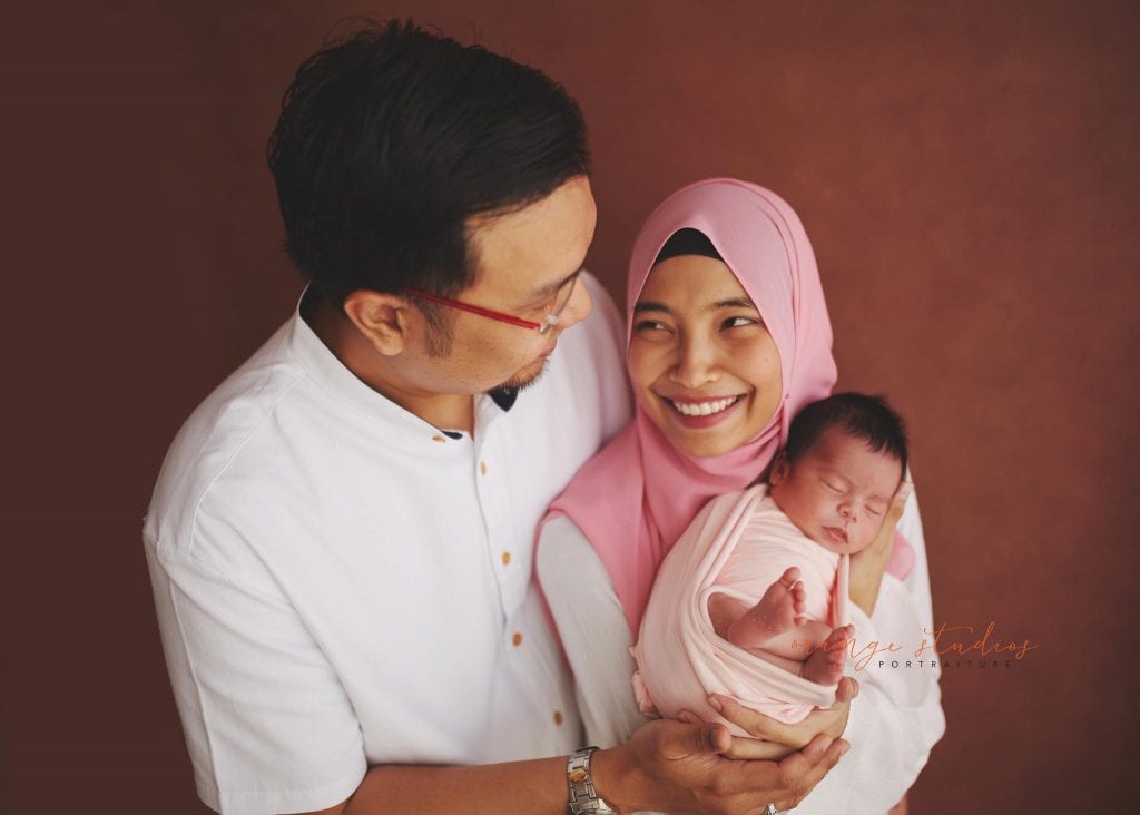 7 days old baby girl newborn portraits with parents in singapore studio