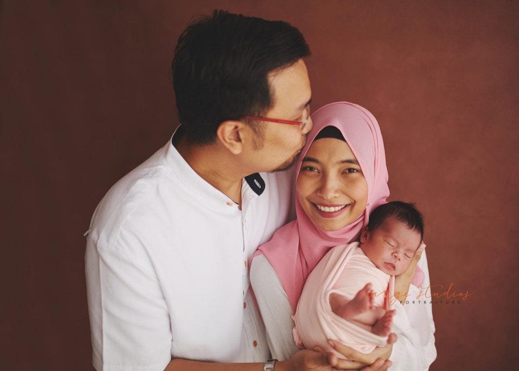 7 days old baby girl newborn portraits with parents in singapore studio