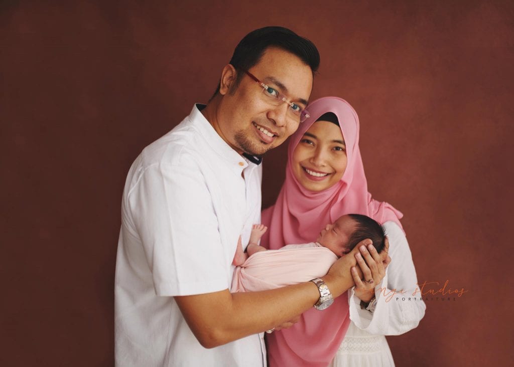 7 days old baby girl newborn portraits with parents in singapore studio