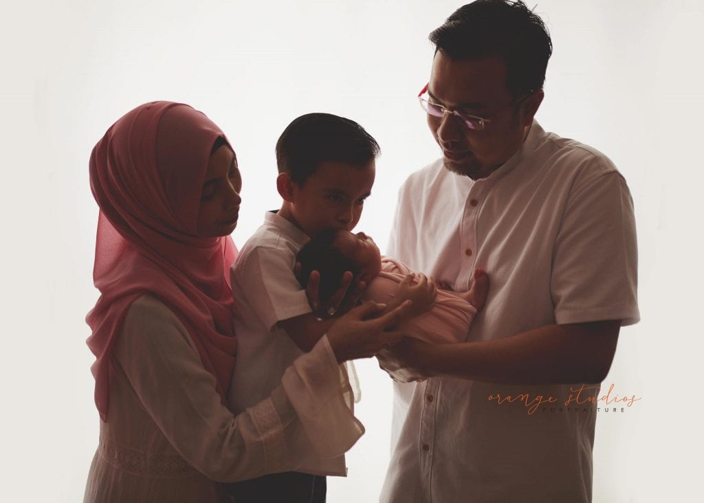 7 days old baby girl with family newborn portraits in singapore studio