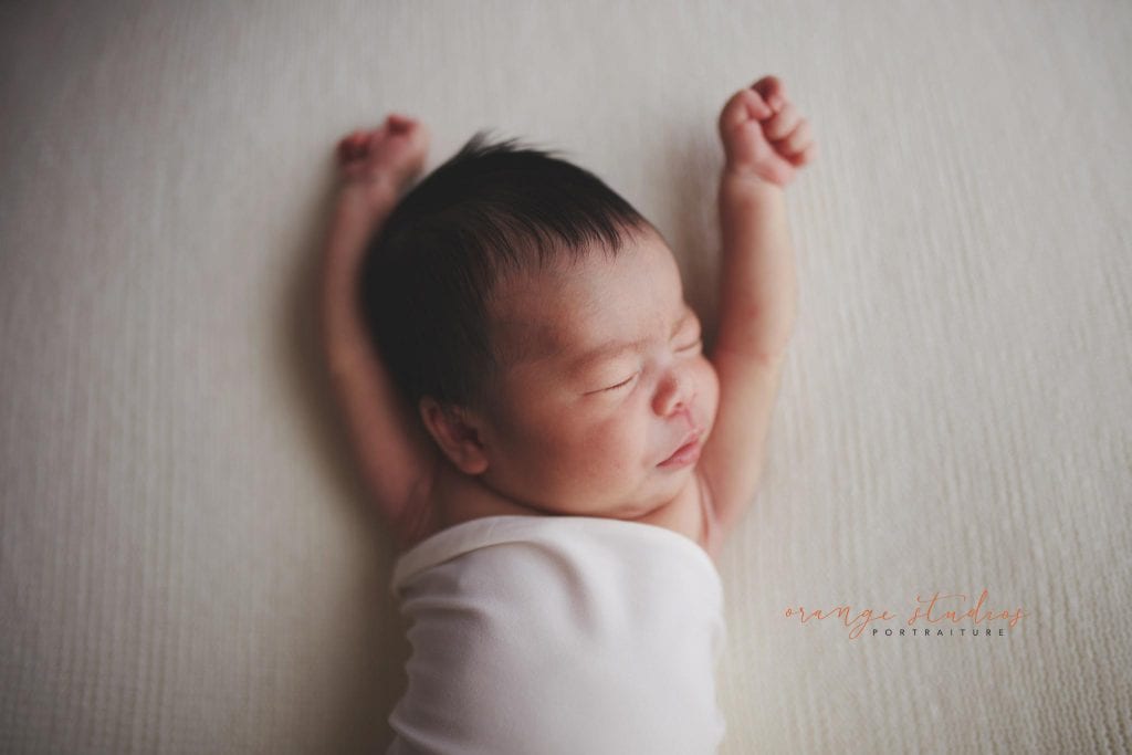 7 days old stretching baby girl newborn portraits in singapore studio