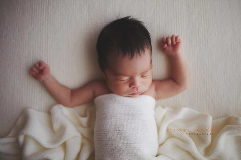 7 days old relaxed baby girl newborn portraits in singapore studio