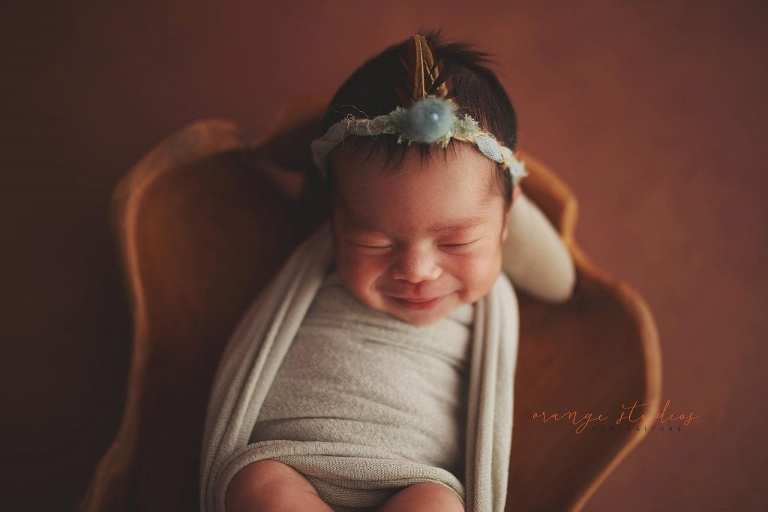 7 days old smiling baby girl newborn portraits in singapore studio
