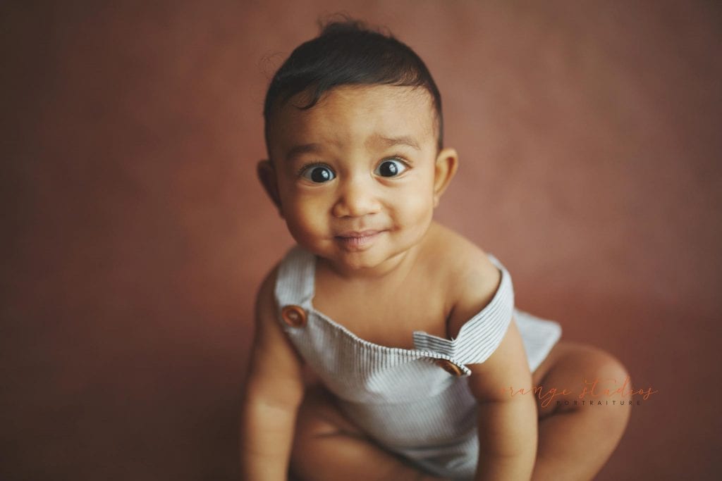 grinning 6 months old baby portraits in singapore natural light studio