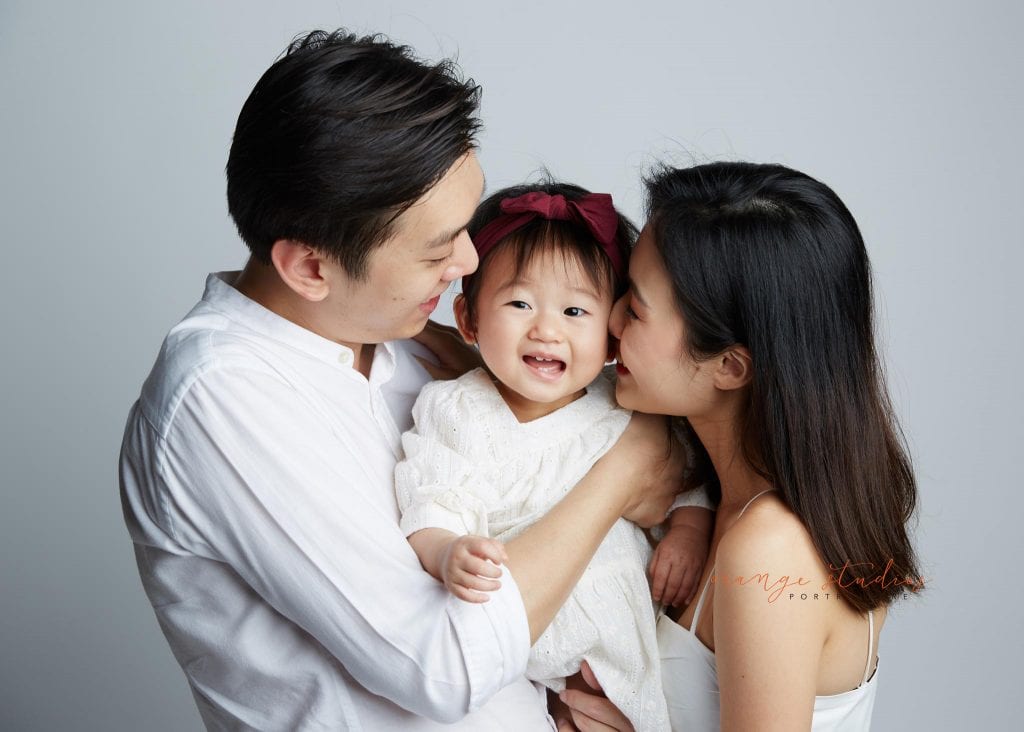 1 year old baby girl with parents family portraits in singapore studio