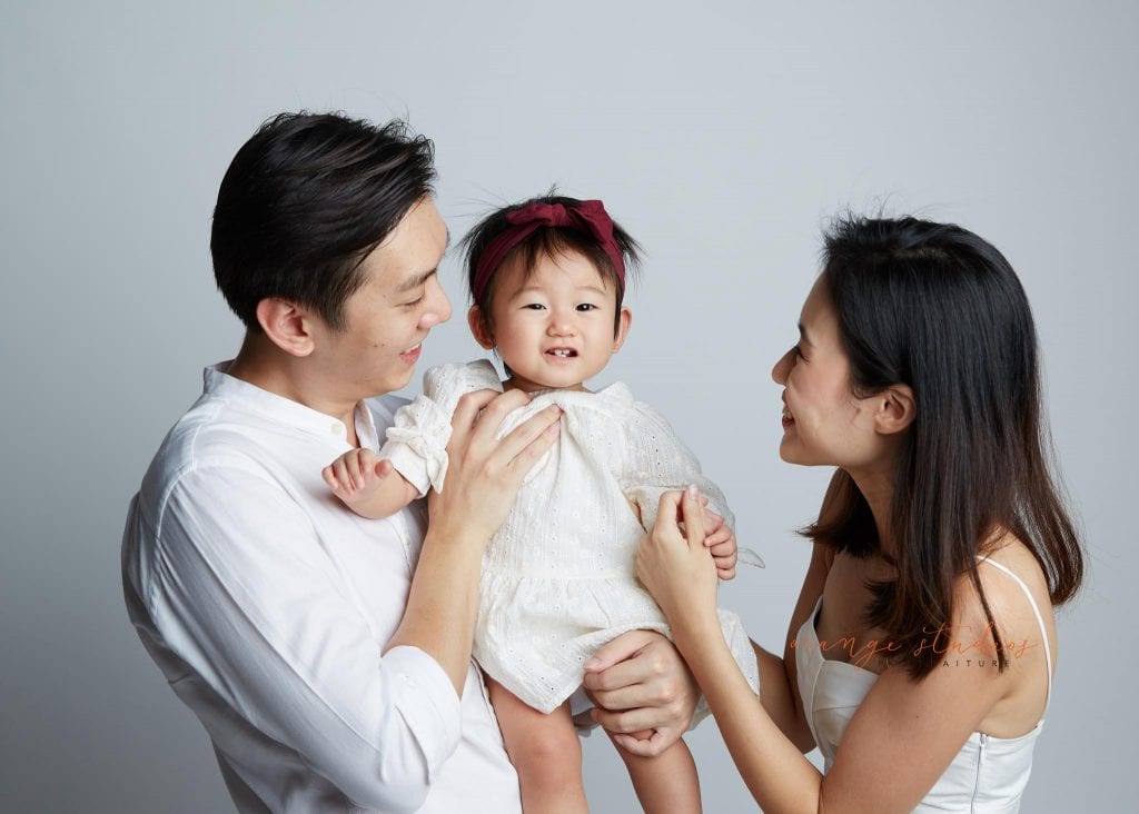 1 year old baby girl with parents family portraits in singapore studio