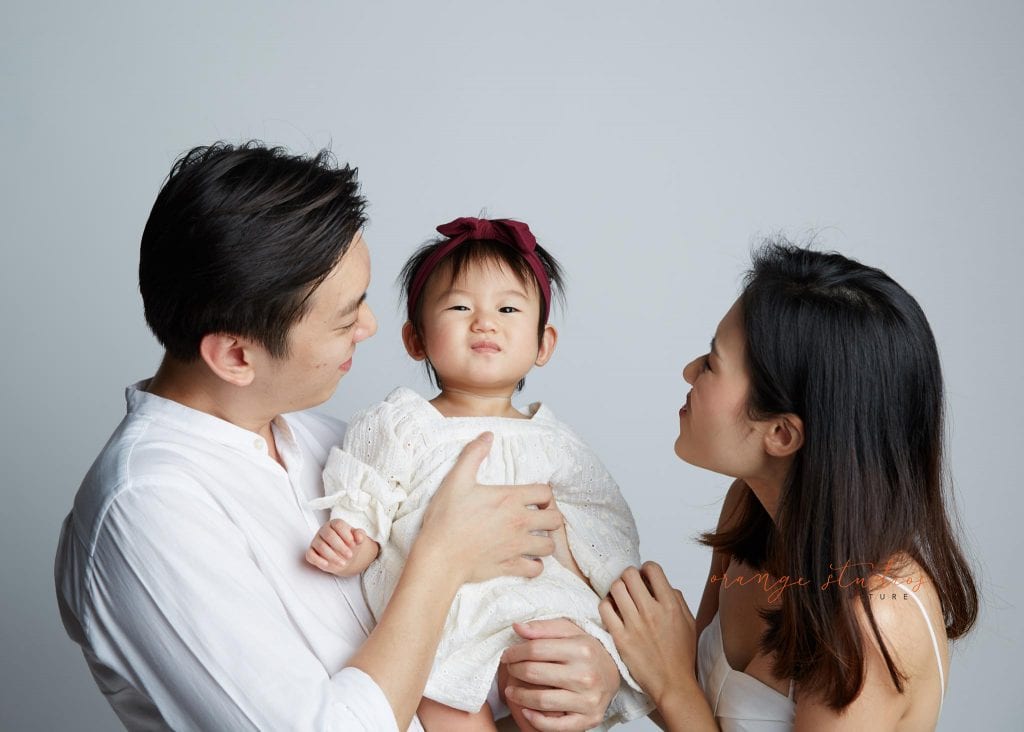 1 year old baby girl with parents family portraits in singapore studio