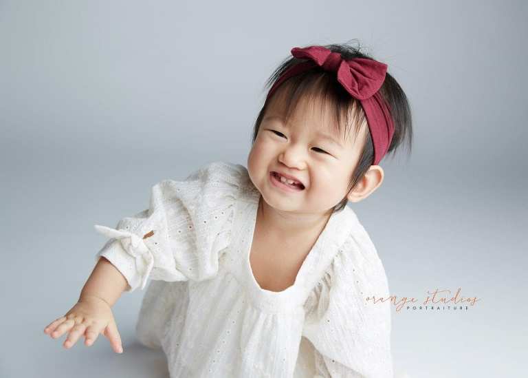 happy 1 year old baby girl portraits in singapore studio