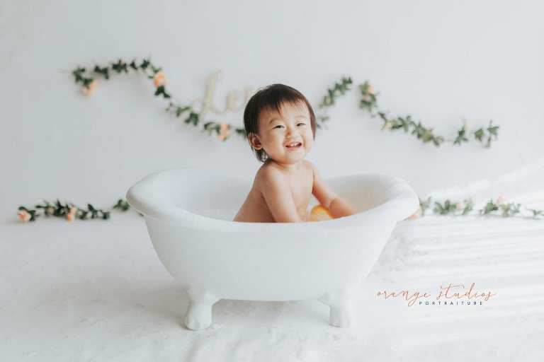 smiling 1 year old baby girl bubble bath portraits in singapore studio natural light