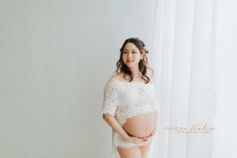 maternity portraits in lacey dress in singapore studio natural light