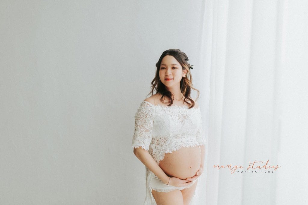 maternity portraits in lacey dress in singapore studio natural light