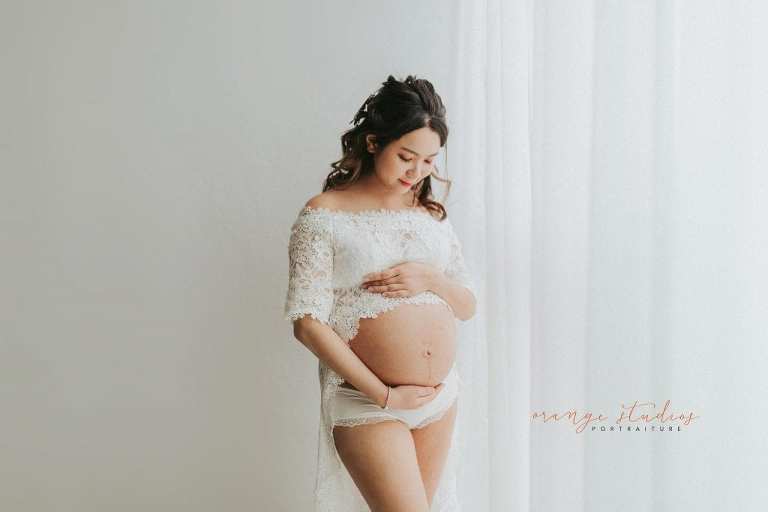 maternity portraits in lacey dress in singapore studio natural light