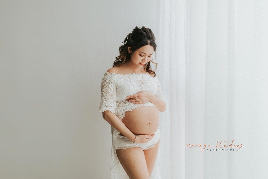 maternity portraits in lacey dress in singapore studio natural light